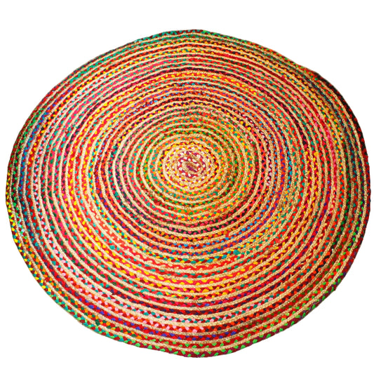 Round multicolored braided rug on a wooden floor