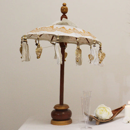 Decorative lamp with intricate design on a plain background