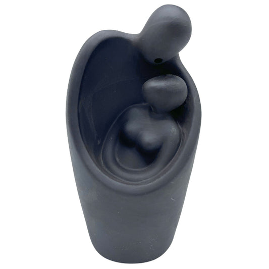 Dark gray ceramic vase with abstract design on a white background