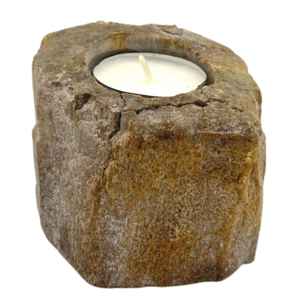 Candle holder made of stone with a lit candle inside on a white background