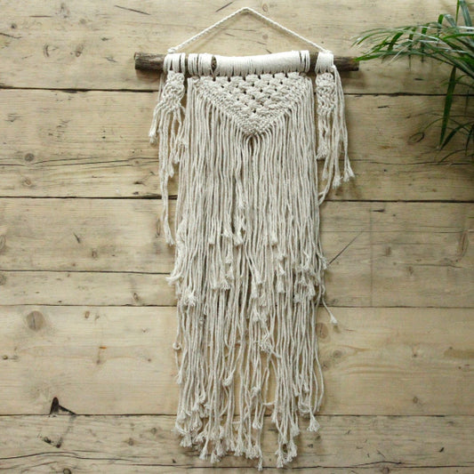 Macrame wall hanging on a wooden wall