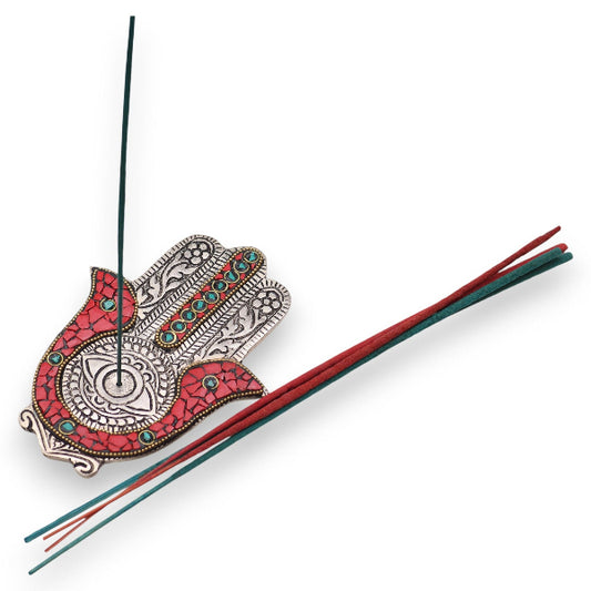 Decorative incense holder with red and silver design on a white background