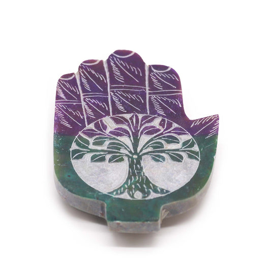 Decorative stone with a tree of life design on a white background