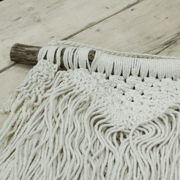 Close-up of a textured white rug on a wooden floor