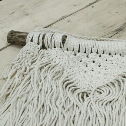 Close-up of a textured white rug on a wooden floor