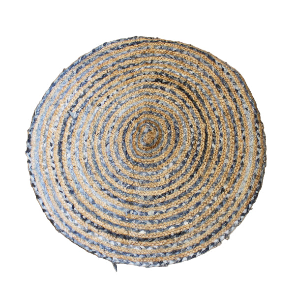 Round woven rug with concentric circles on a wooden floor