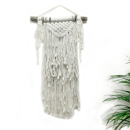 Macrame wall hanging with white threads on a white background