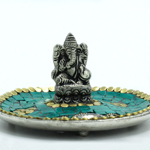 Decorative incense holder with Ganesha statue on a white background