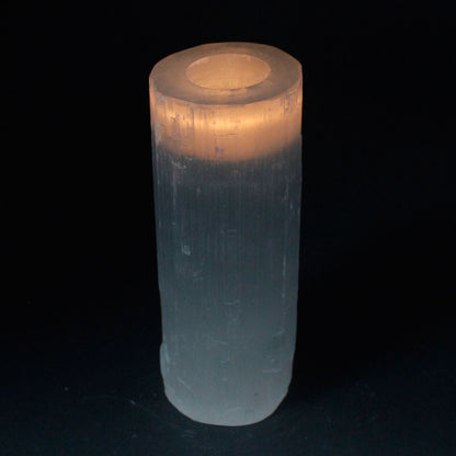 Clear cylindrical crystal with a glowing interior on a black background