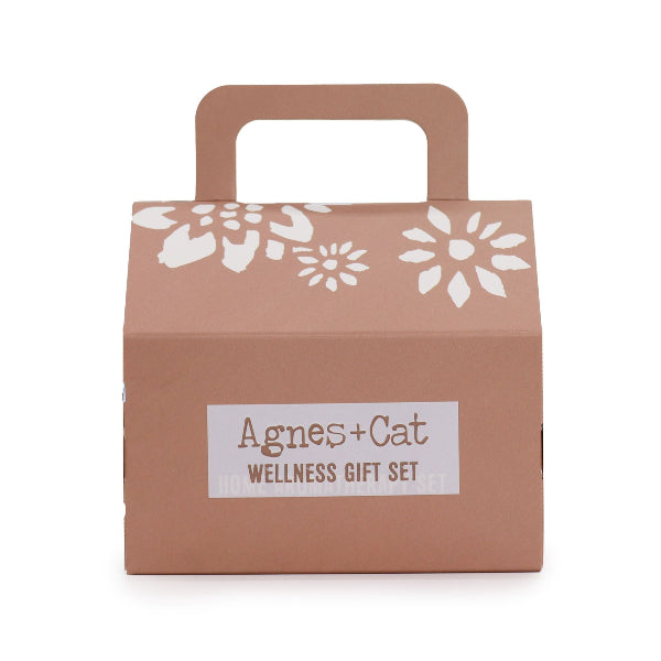 Brown gift box with white floral patterns and 'Agnes + Cat Wellness Gift Set' label on a white background
