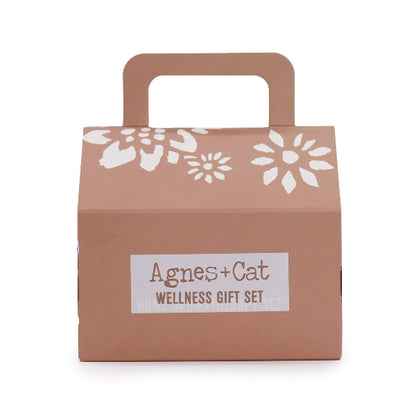 Brown gift box with white floral patterns and 'Agnes + Cat Wellness Gift Set' label on a white background