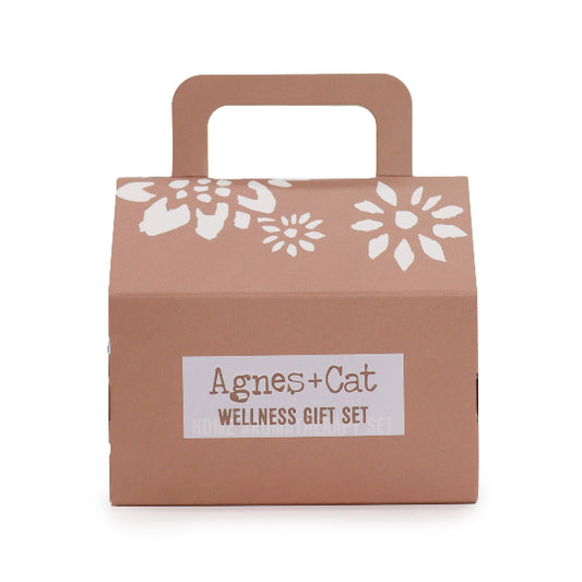 Brown gift box with white floral patterns and 'Agnes + Cat Wellness Gift Set' label on a white background