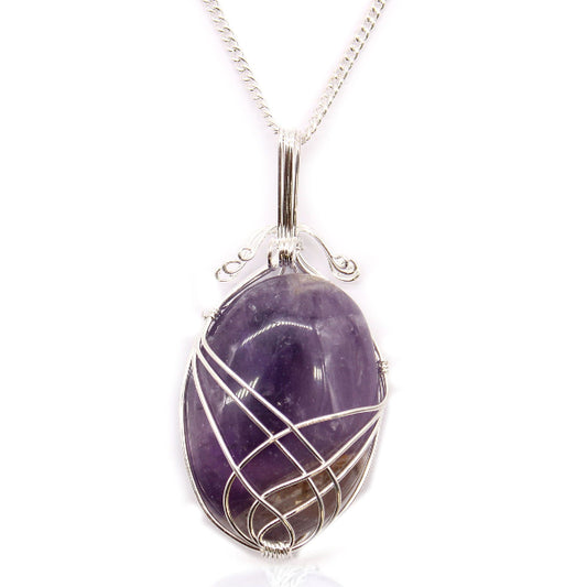 Amethyst pendant with silver wire wrapping on a white background