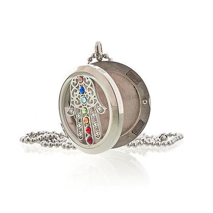 Decorative locket with colorful stones on a white background