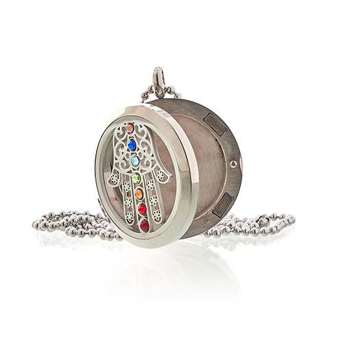 Decorative locket with colorful stones on a white background
