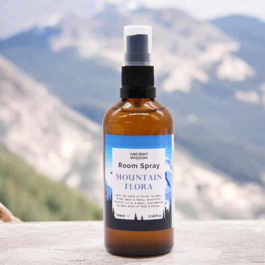 Room spray bottle labeled 'Mountain Flora' with a mountainous background