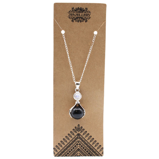Necklace with a black teardrop pendant on a brown jewelry card