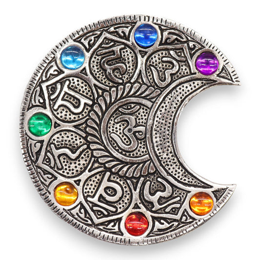 Decorative metal piece with colorful gemstones on a white background