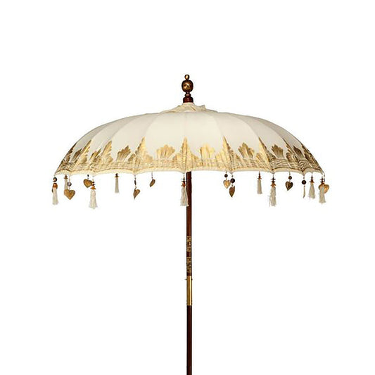 Decorative umbrella with tassels and heart shapes on a white background