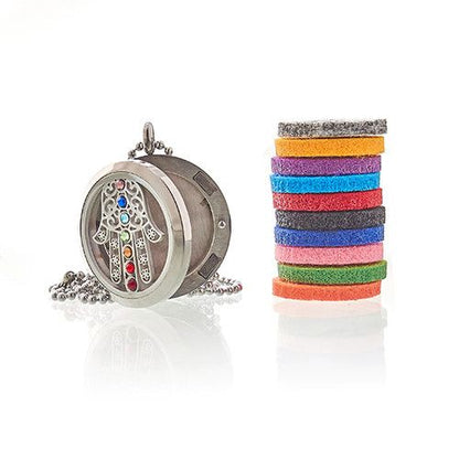 Decorative circular pendant with colorful stones and a stack of multicolored hair ties on a white background