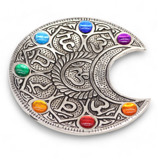 Decorative plate with a crescent moon design and colorful stones on a white background