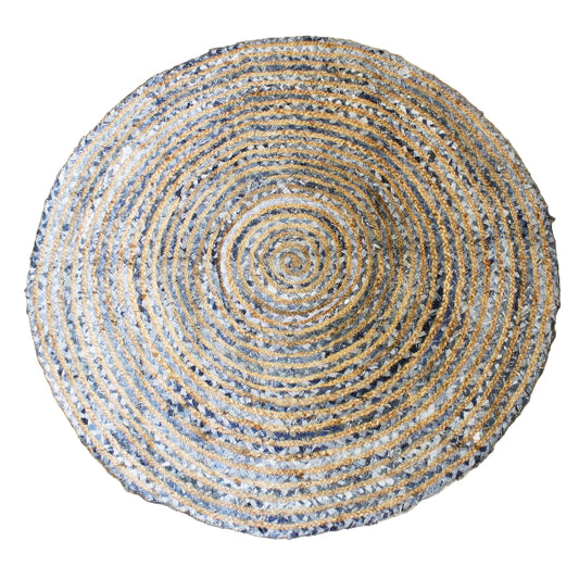 Round woven rug with concentric circle pattern on a wooden floor
