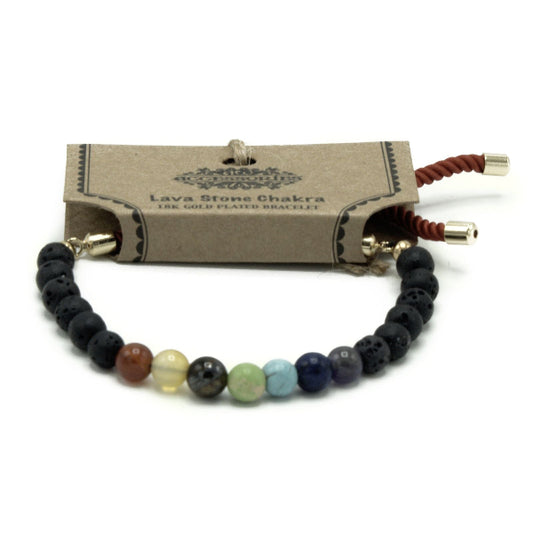 Lava stone chakra bracelet with a branded box on a white background