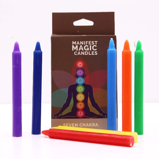 Set of colorful candles with a 'Manifest Magic Candles' packaging featuring seven chakra symbols.