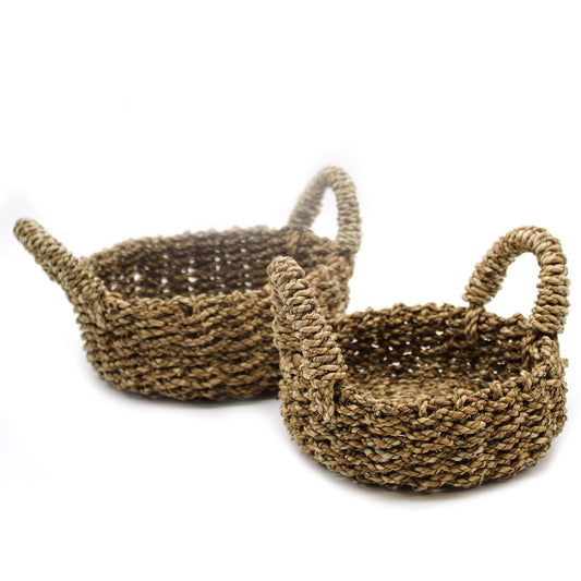 Two woven baskets with handles on a white background