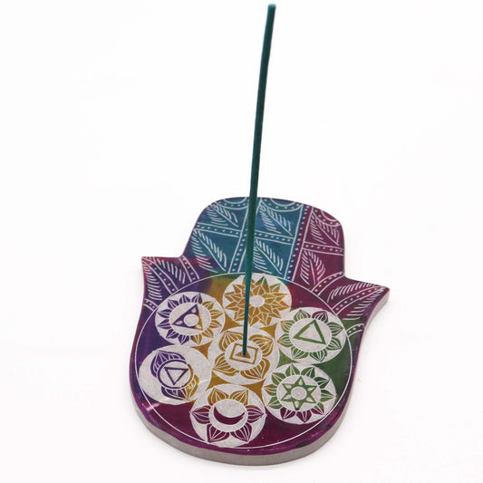 Decorative Hamsa-shaped incense holder with colorful patterns on a white background