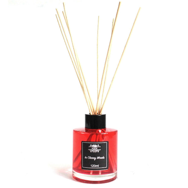 Red diffuser bottle with wooden sticks on a white background
