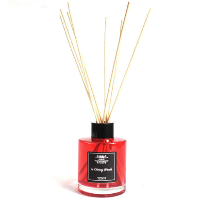 Red diffuser bottle with wooden sticks on a white background