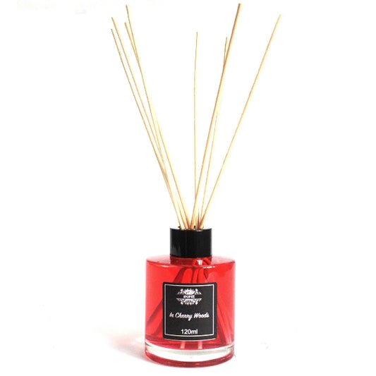 Red diffuser bottle with wooden sticks on a white background
