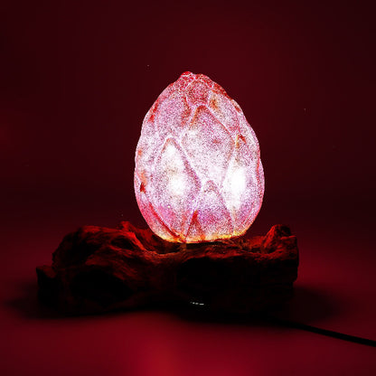 Pink crystal egg-shaped lamp on a dark red background