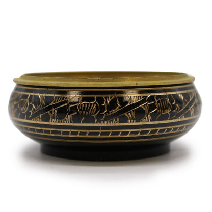 Decorative bowl with gold and black patterns on a white background