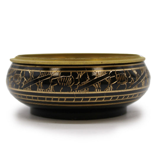 Decorative bowl with gold and black patterns on a white background