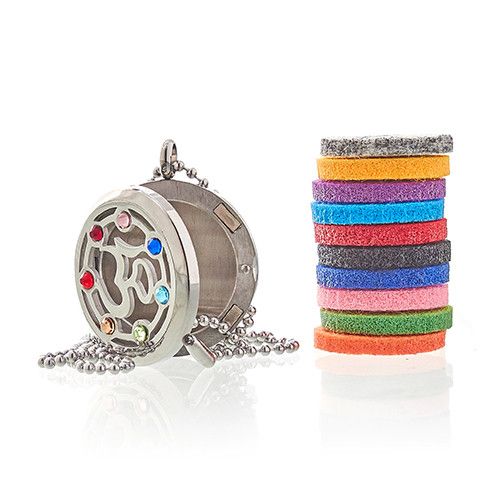 Silver locket with colorful stones and a stack of colorful bands on a white background