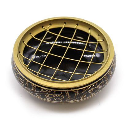 Decorative black and gold circular object with grid pattern on a white background