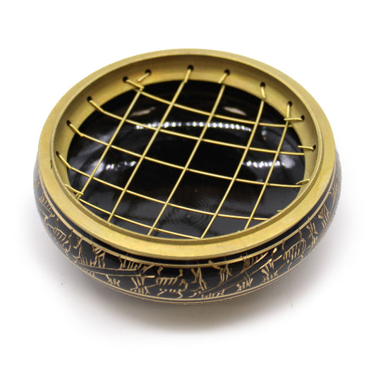 Decorative black and gold circular object with grid pattern on a white background