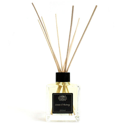 Reed diffuser with wooden sticks and a black cap on a white background