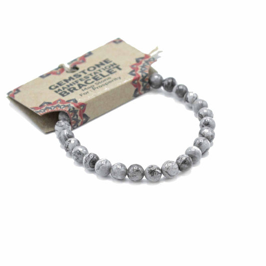 Gray beaded bracelet on a white background with a branded card.
