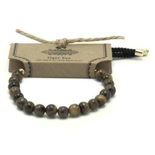 Tiger eye beaded bracelet with gold clasp on a cardboard tag, on a white background