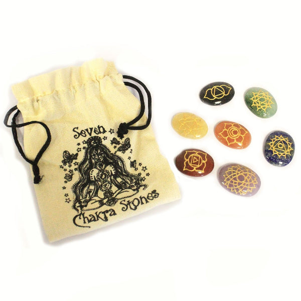Set of seven chakra stones with a drawstring bag on a white background